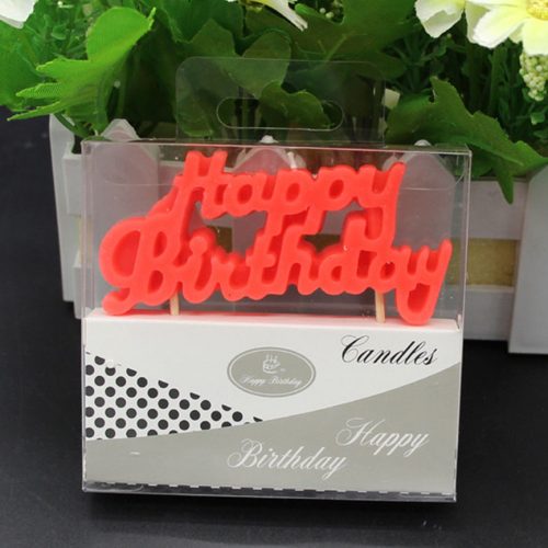 A red candle saying Happy Birthday