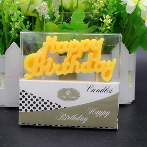 A yellow candle saying Happy Birthday