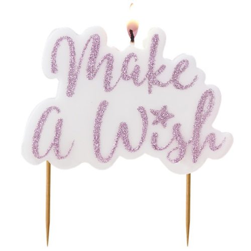 a photo of a cake candle showing make a wish written in pink glitter