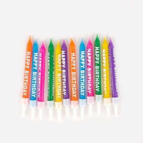 12 Multi-colour birthday cake candles with happy birthday text in white down the side